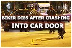 Motorcyclist dies after crashing into car door